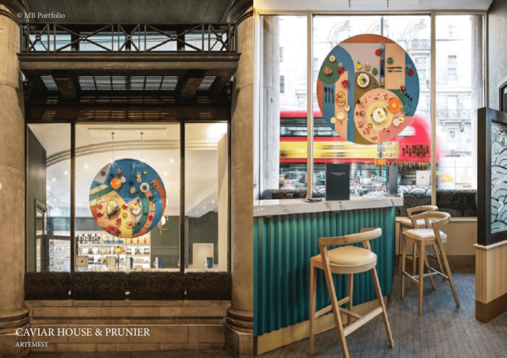 Interior view of caviar house & prunier restaurant showing a bar area with teal stools and decorative circular wall art, with a street scene visible through large windows.