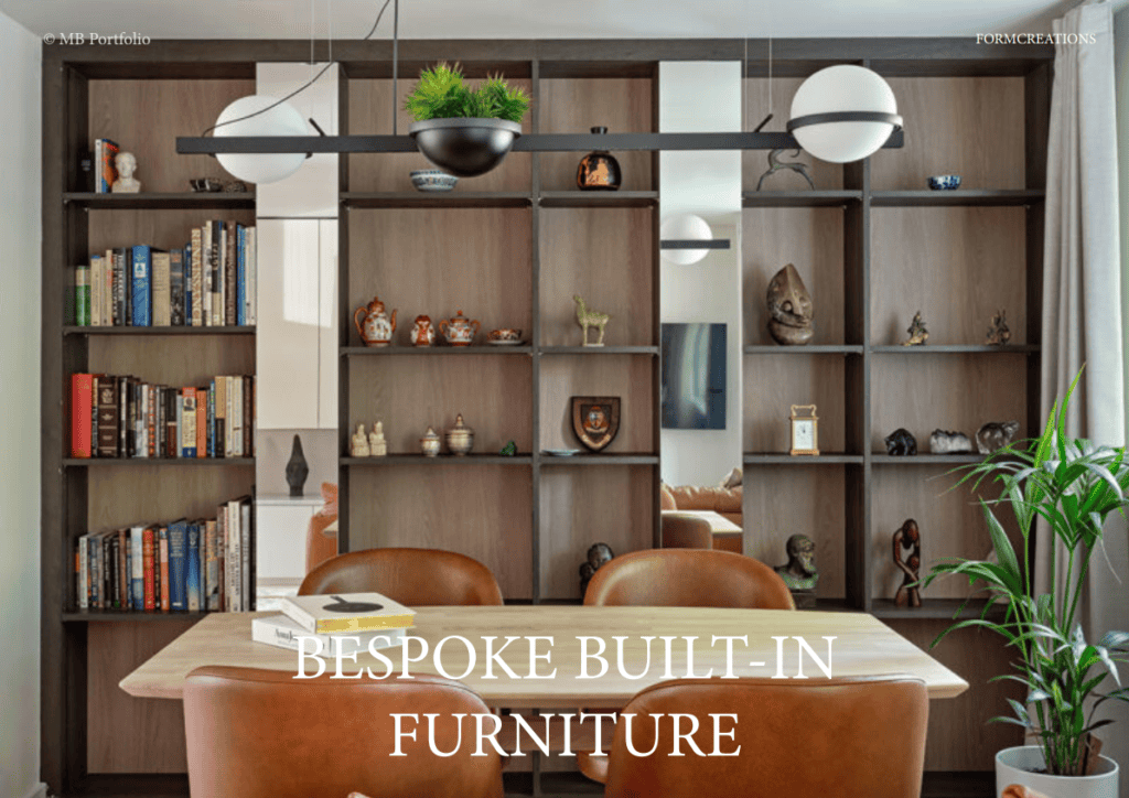 A cozy reading nook with bespoke built-in wooden shelving filled with books and various decor items, flanked by comfortable leather chairs and hanging pendant lights.