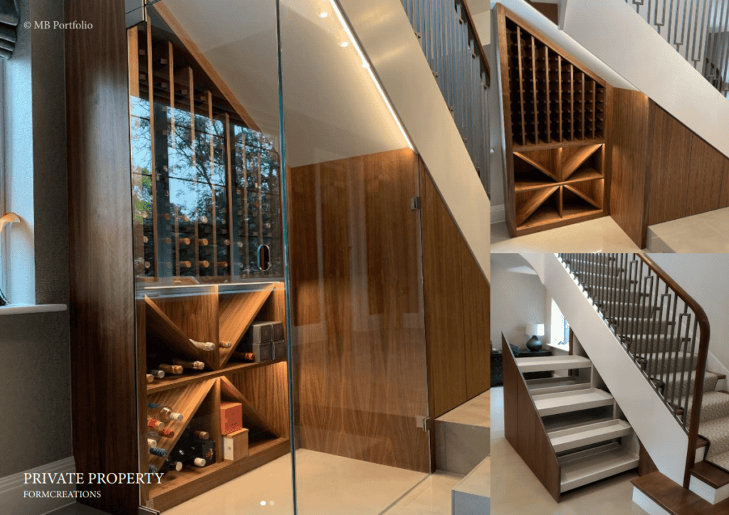 An elegant interior featuring a staircase with white and dark wood accents and an adjacent glossy wooden bookcase with various compartments and wine storage, reflecting off a glass panel.